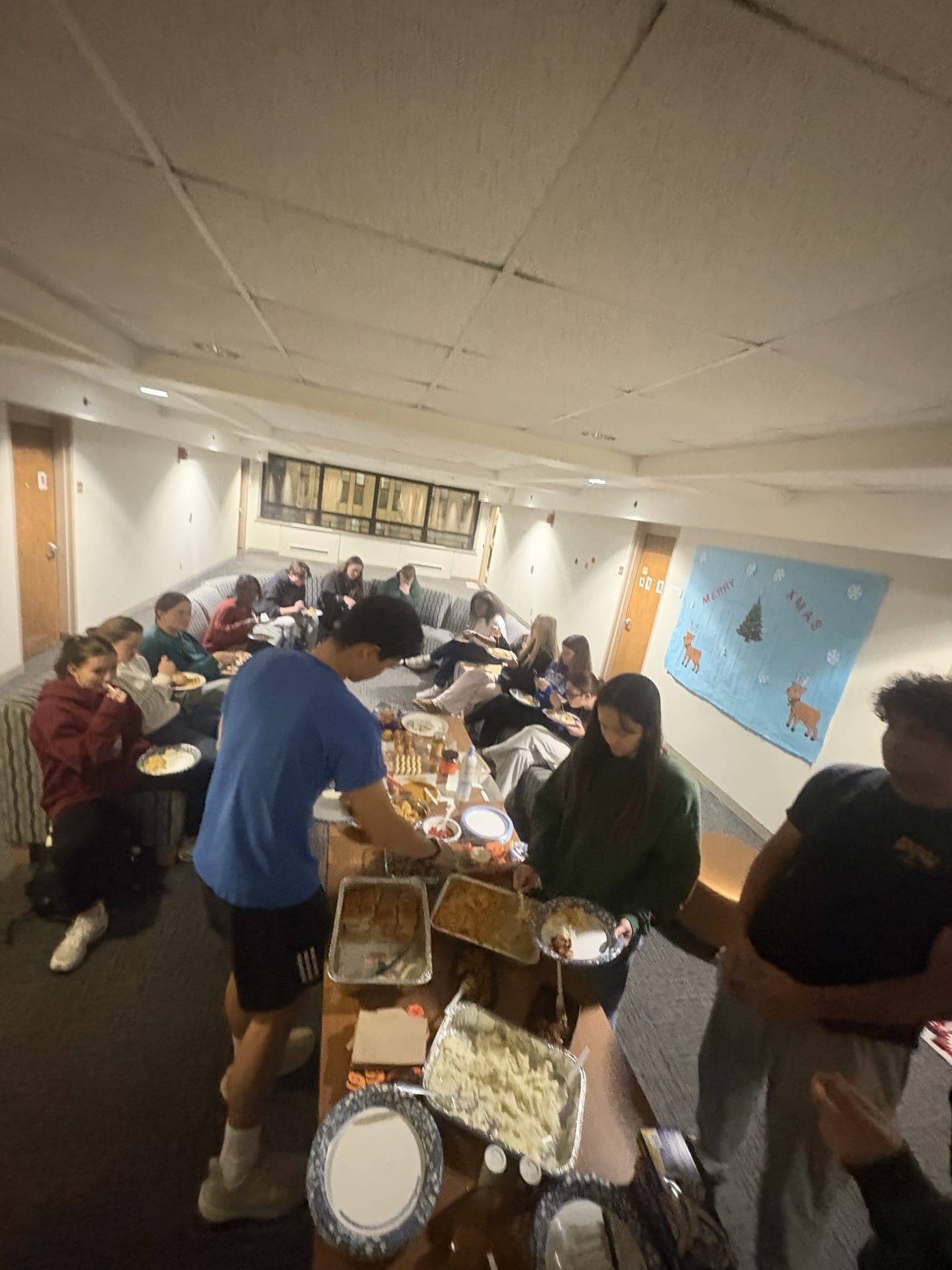Residents gathered around a table of shared dishes.