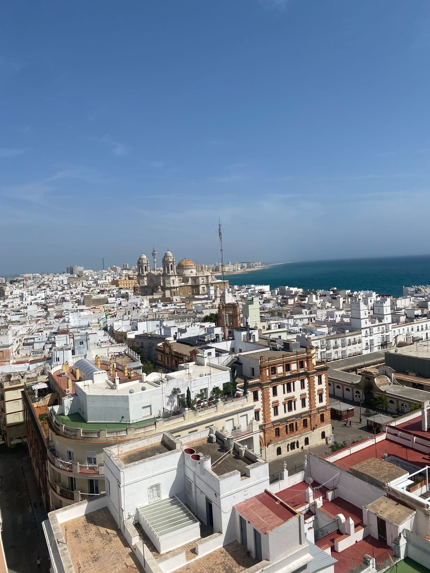 A high view out over the rooftops of Cádiz towards the sea.