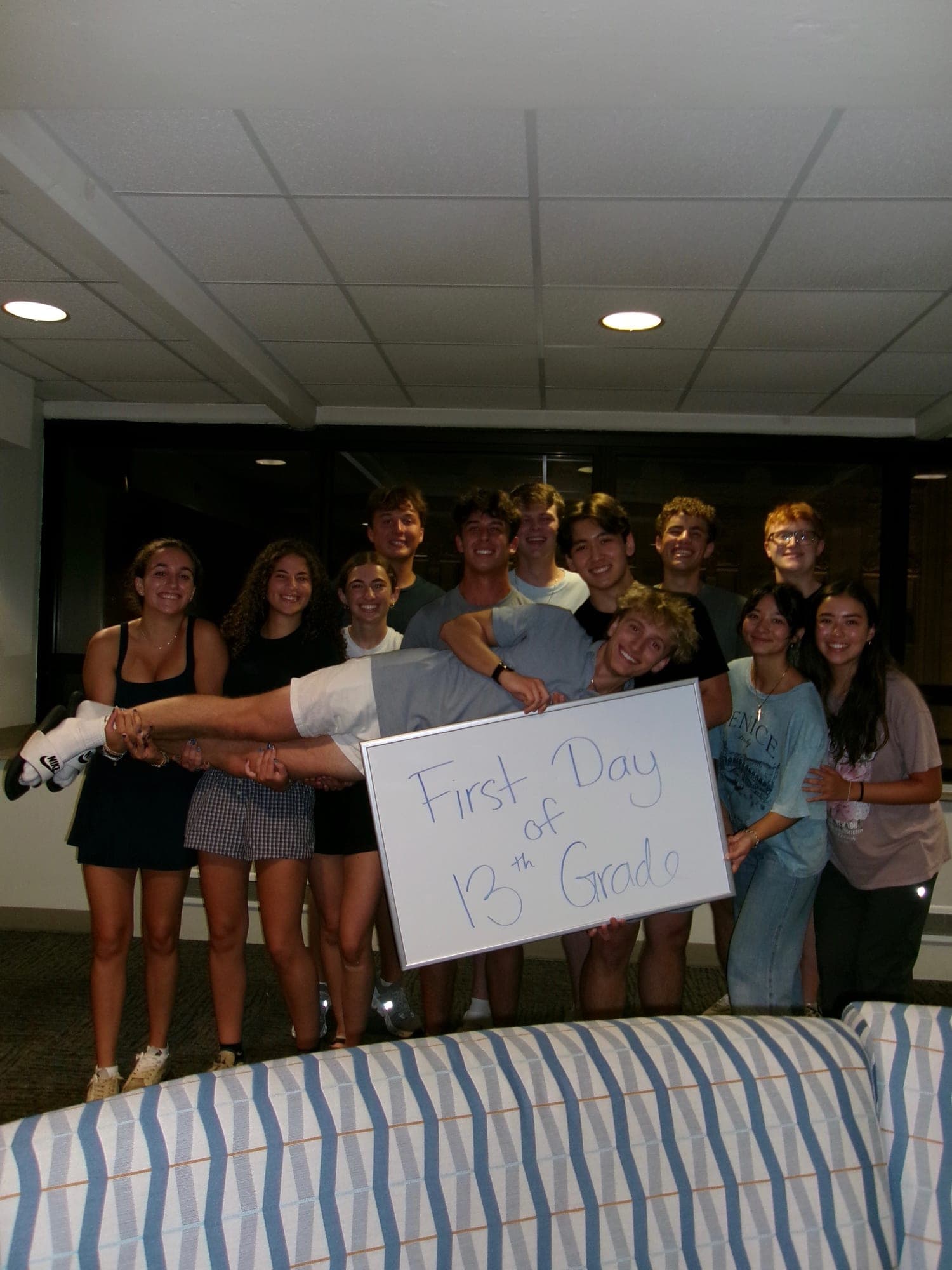 A group of residents lifting me up off the ground, all of them laughing.